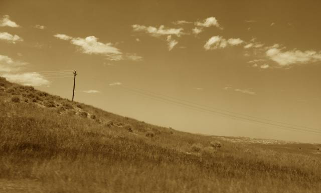 Telephone pole on a hill